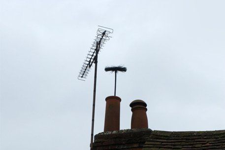 Cleaning brush extending through chimney pot - Dave The Chimney Sweep the experts keeping chimneys clean and safe in East Cornwall, Plymouth, Saltash and West Devon